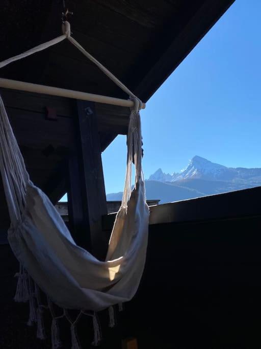 a white hammock hanging from a building with a view at NEUES ruhiges Apartment, Bergblick, Stellplatz in Bischofswiesen