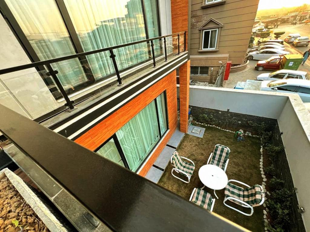 a balcony with a table and chairs on a building at COMFORT & LUXURY HOME in Islamabad