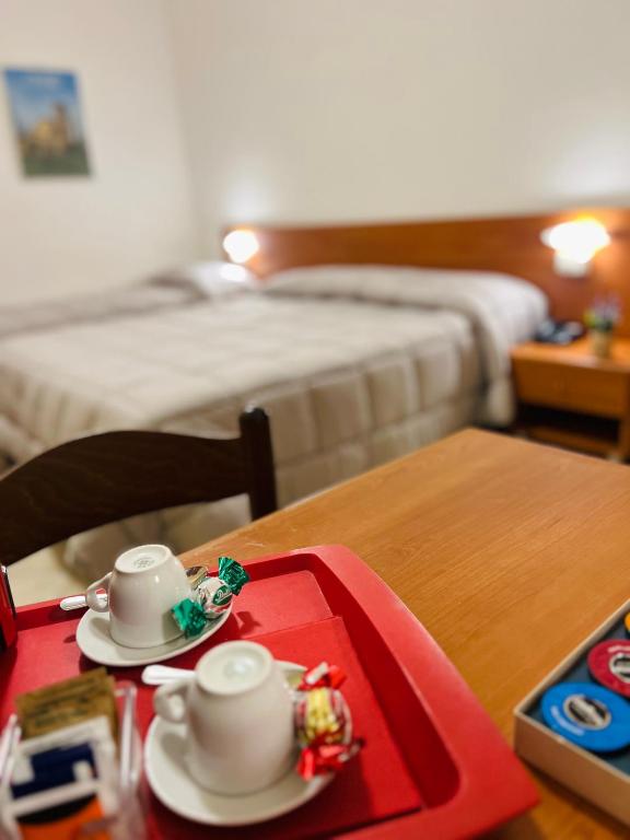 Postel nebo postele na pokoji v ubytování Hotel Vico Alto Siena