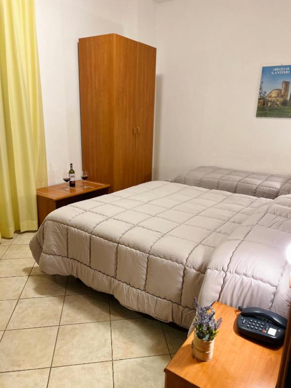 Postel nebo postele na pokoji v ubytování Hotel Vico Alto Siena