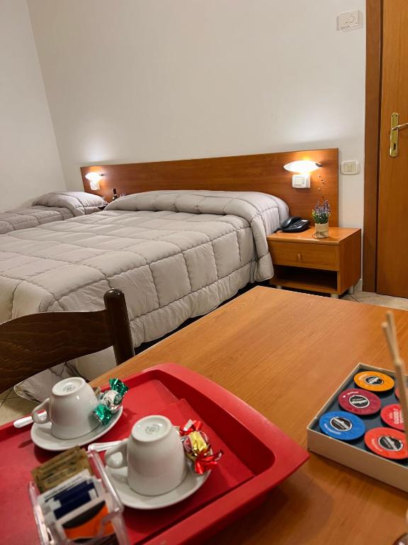 Postel nebo postele na pokoji v ubytování Hotel Vico Alto Siena