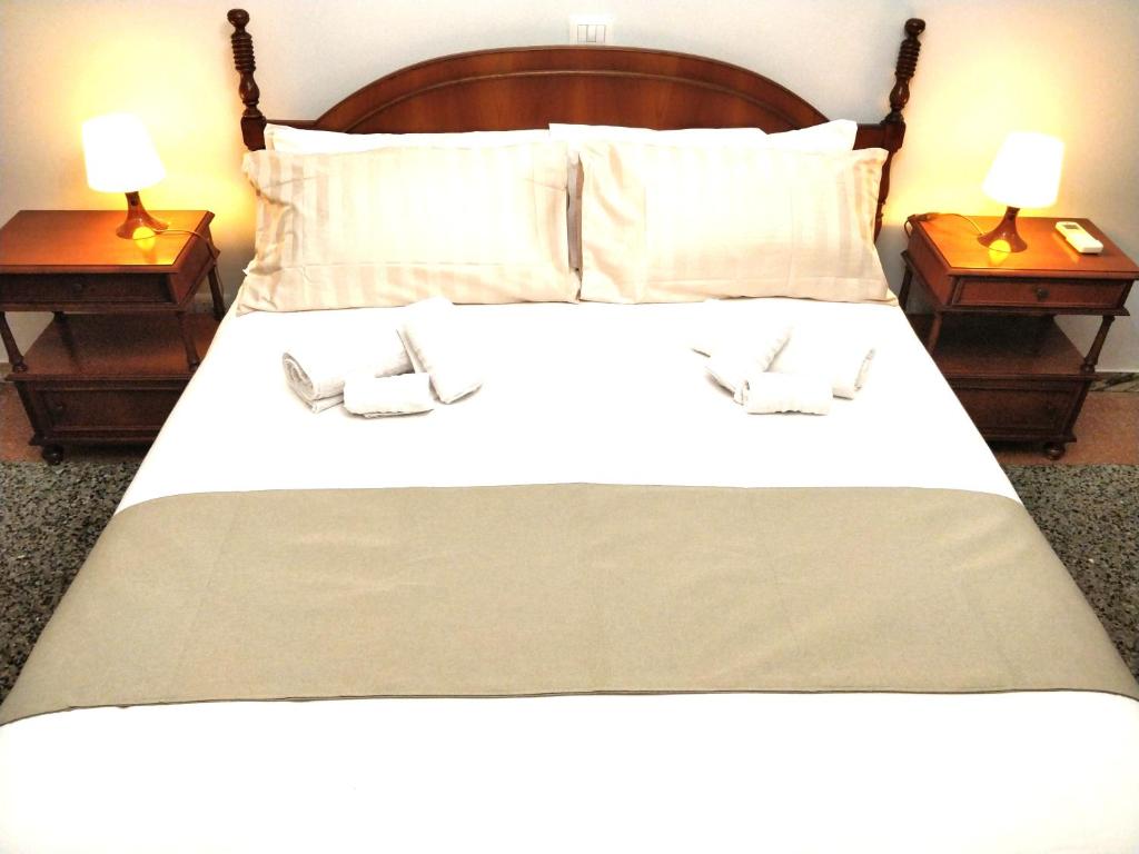 a large bed with two nightstands and two lamps at La Dimora di Enea in Rome