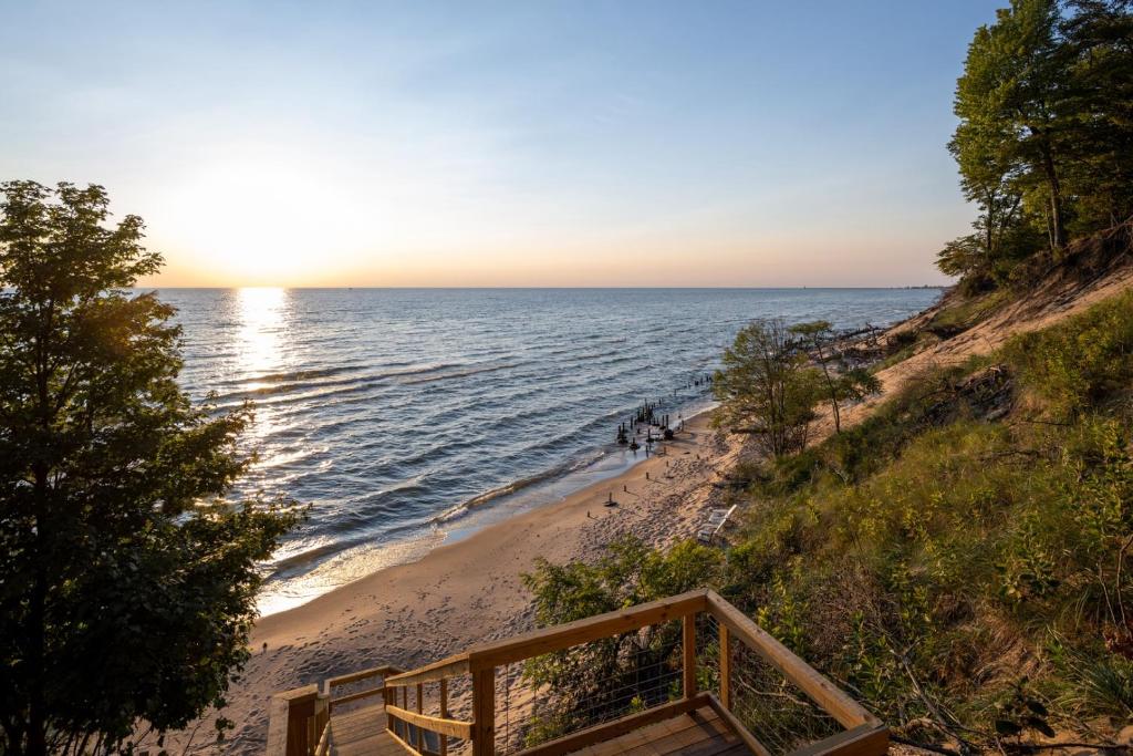 a view of the ocean from a beach with a wooden staircase at Relax on Lake Michigan at Tranquil Shores in Norton Shores