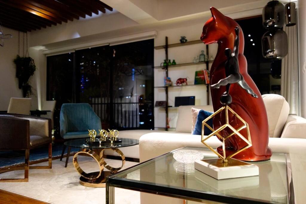 波哥大的住宿－Bespoke Suite, Unique Location, Complementary Airport Pick Up，客厅,玻璃桌上摆放着马雕像