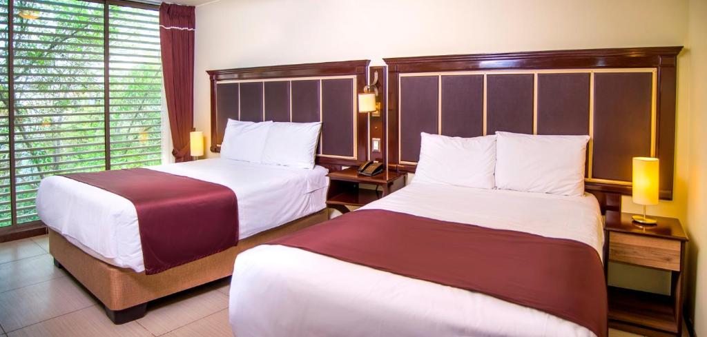 Postel nebo postele na pokoji v ubytování Hotel D'Carlo Class
