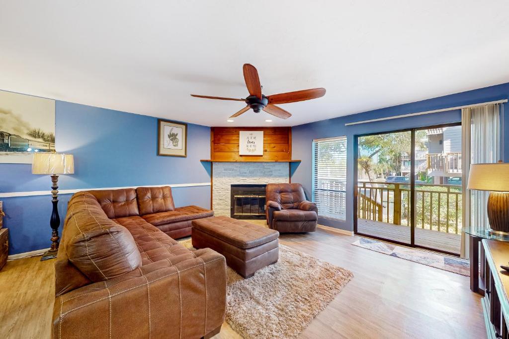 a living room with a couch and a ceiling fan at Ocean Mile B2 in St. George Island