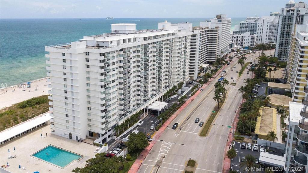 an aerial view of a large white building next to the beach at Pavilion Beach Front Apartment with Balcony in Miami Beach