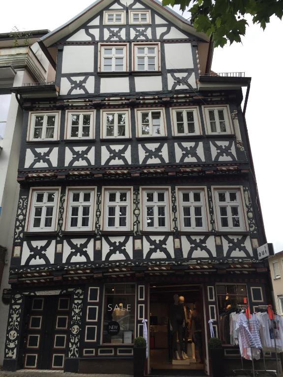 a black and white building with white windows at Baumeisterhaus Apartment in Bad Hersfeld