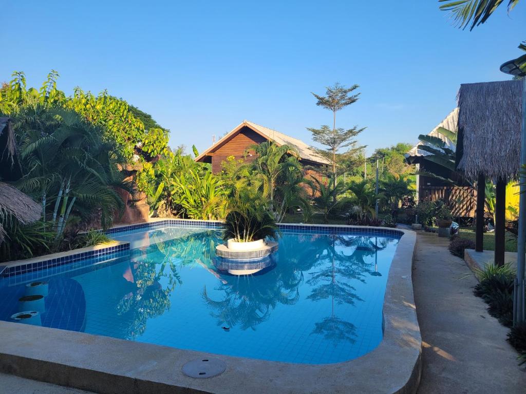 a swimming pool in front of a house at Mister check paradise in Si Chiang Mai