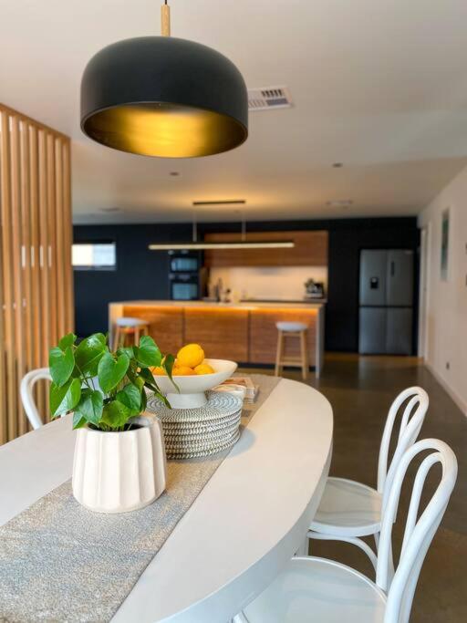 - une cuisine avec une table et un vase de fruits dans l'établissement 'Shore Thing' - Akaroa, à St Helens