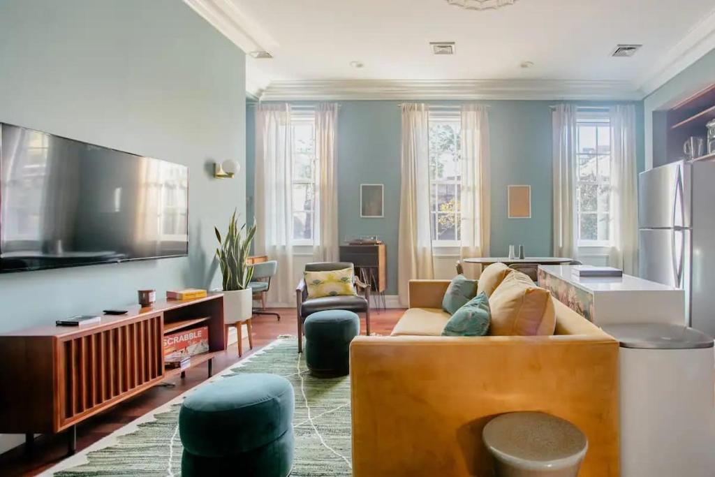 a living room with a couch and a tv at Airy Greenwich Retreat with Private Deck in New York