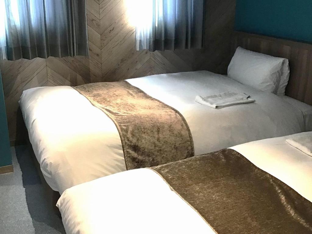 Postel nebo postele na pokoji v ubytování Matsue Urban Hotel