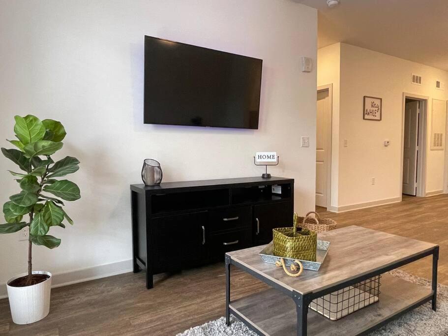 a living room with a flat screen tv on a wall at Modern 1br - 15 from Airport in Stockbridge