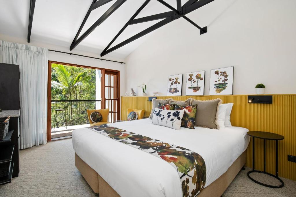a bedroom with a large bed and a tv at Tamborine Mountain Glades in Mount Tamborine