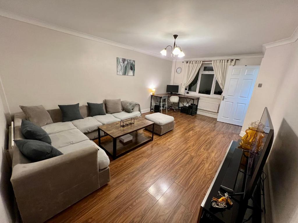 a living room with a couch and a table at Entire 3 bedroom end of terrace house! in Thamesmead