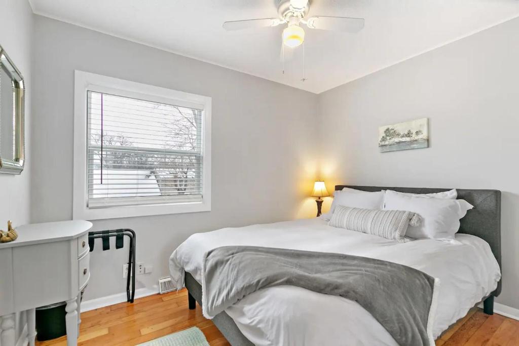 a white bedroom with a bed and a window at 127 Oakwood Hills in Oakwood Hills