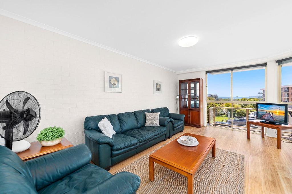 a living room with a couch and a tv at Seaspray Unit 3 4 Intrepid Close in Nelson Bay