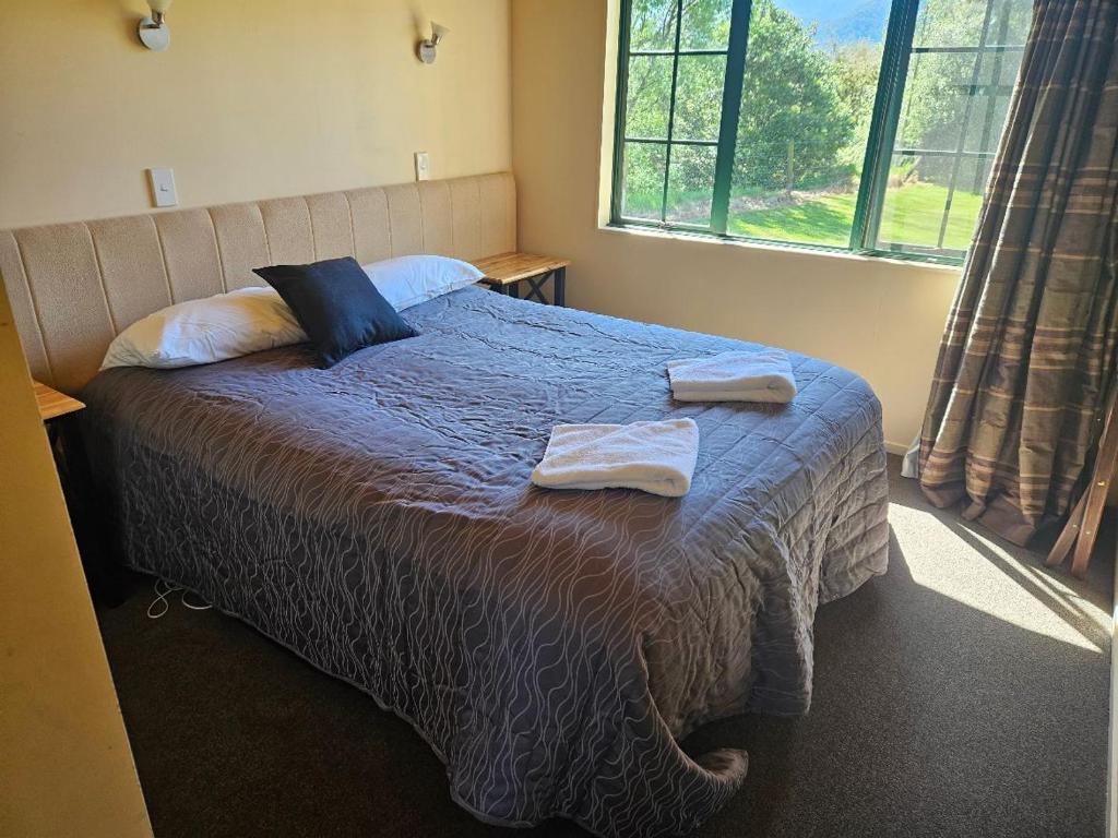 Postel nebo postele na pokoji v ubytování Kiwi Park Motels