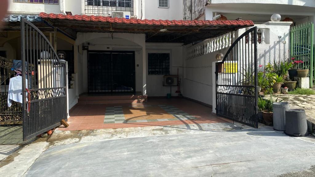 an entrance to a house with an iron gate at Homestay Dyzas in Batu Caves