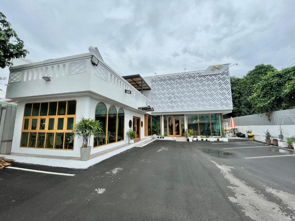 a white building with a lot of windows at Nan Cozy House in Nan