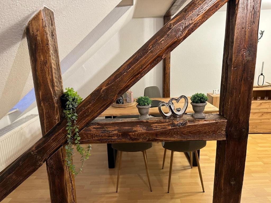a wooden table with glasses and plants on it at Ferienwohnung Jule in Wernigerode