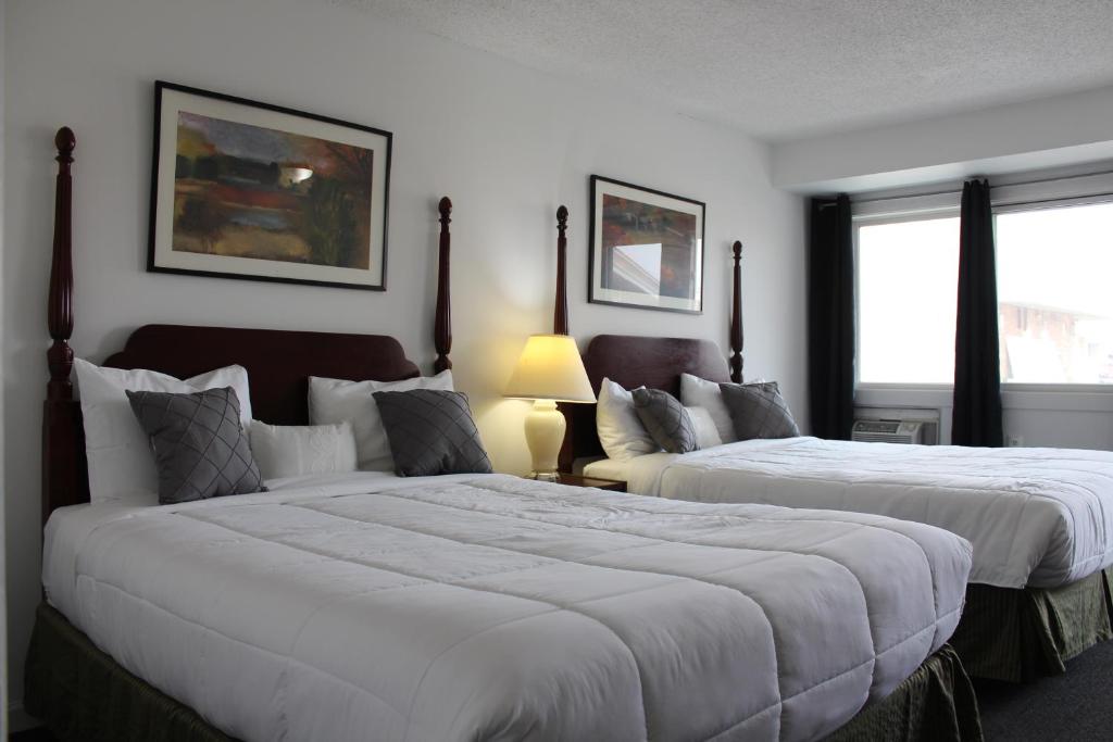 a hotel room with two beds and a window at Midtown Inn in Saskatoon