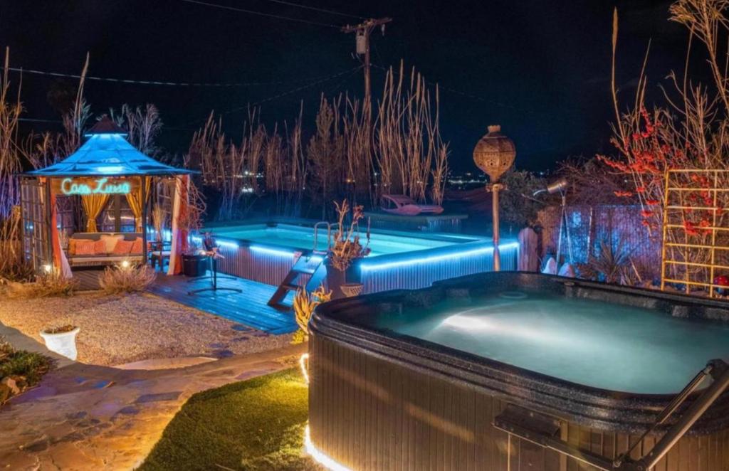 a swimming pool at night with aperatureverningfficientfficientfficientfficientfficient at Casa Luisa Joshua Tree in Joshua Tree