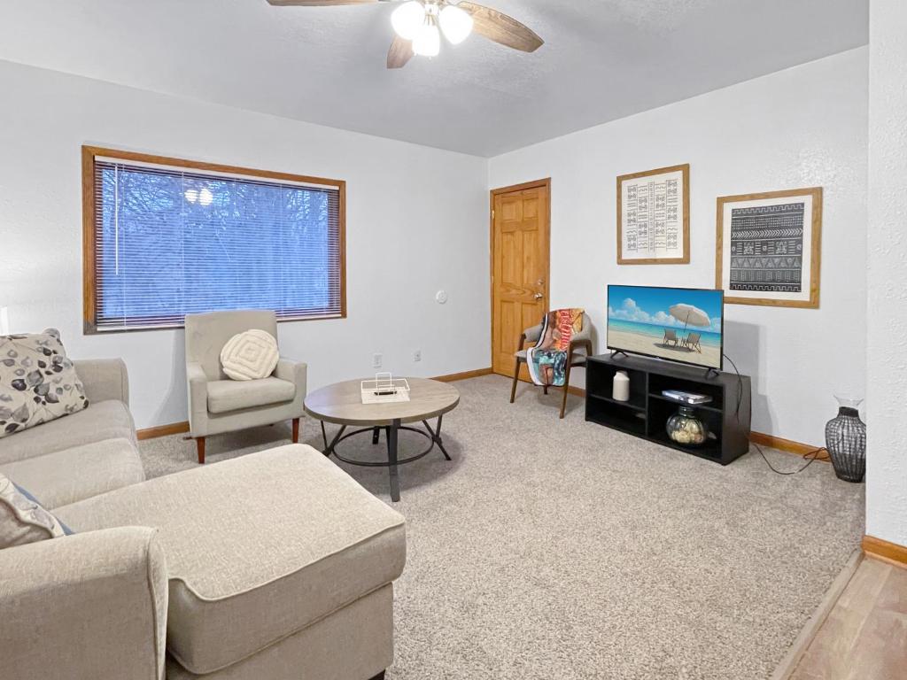 a living room with a couch and a tv at 3bed Cozy House In Quiet Neighborhood in Des Moines