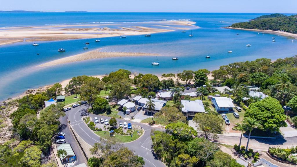 an aerial view of a beach with boats in the water at Sunset Cabins 1770 in Seventeen Seventy