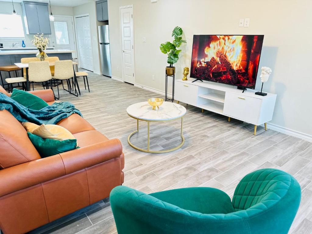 a living room with a couch and a tv at Modern apt-King bed-Free parking-Wi-fi in Brownsville