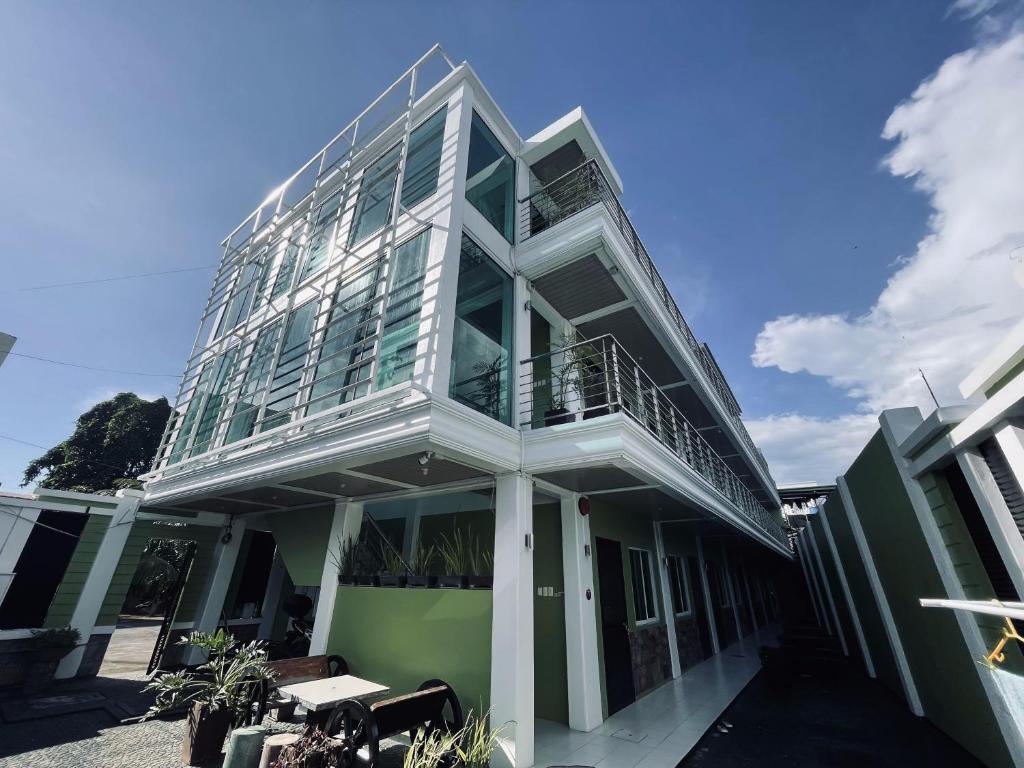 a green and white building with a balcony at Delta Star Manor in Naga