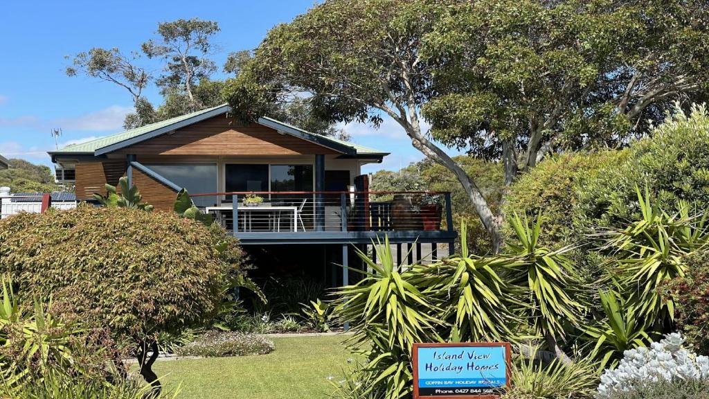 a house with a porch and a sign in front of it at Island View 2 in Coffin Bay