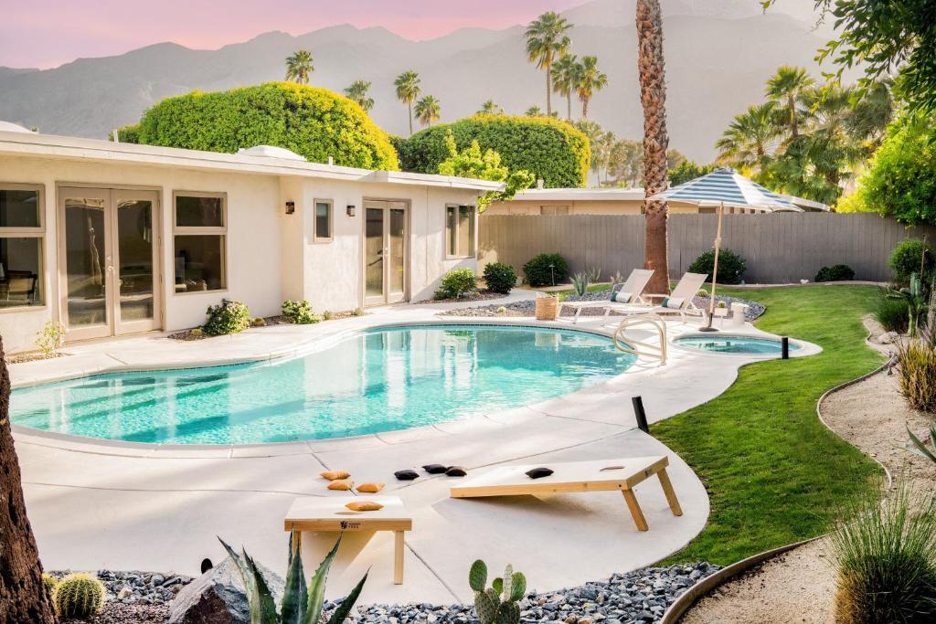 a pool in the backyard of a house at El Mirador by AvantStay Canyon Views Large Pool Outdoor Grill Games Permit4253 in Palm Springs