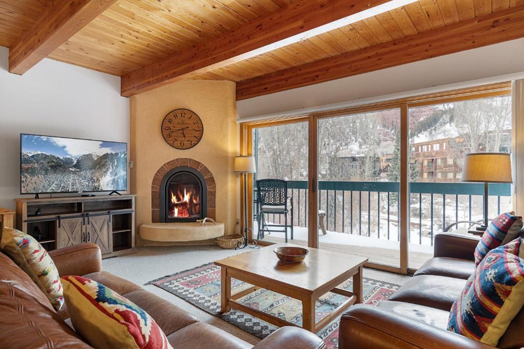a living room with a couch and a fireplace at Riverside Condos D01 by AvantStay Condo Close To Downtown Town Park Ski Lift 8 in Telluride