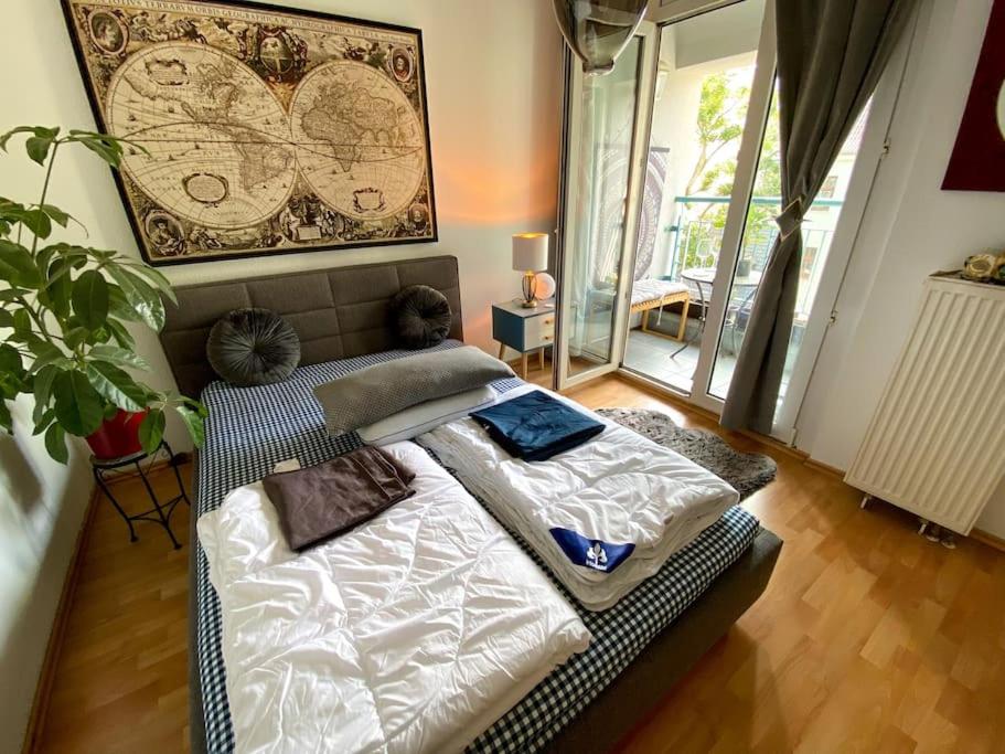 a bedroom with a large bed with white sheets at Beautiful bright apartment with balcony/10’ Mitte in Berlin