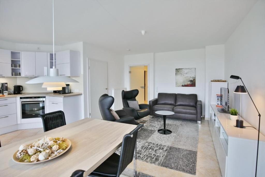 a kitchen and living room with a table and chairs at Am Seedeich 14, AS7 in Cuxhaven