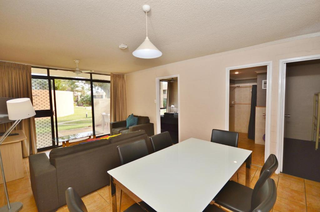a dining room with a white table and chairs at Riverview Holiday Apartment 78 - Kalbarri WA in Kalbarri