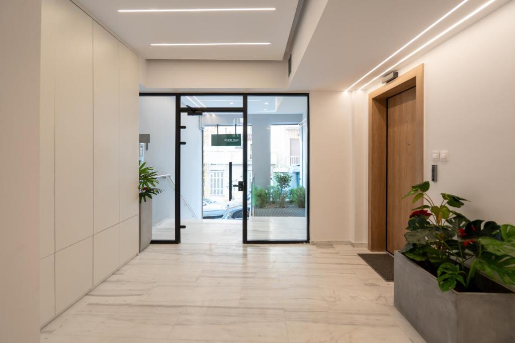 an office corridor with doors and potted plants at Athens Hills, Boutique Apartments in Athens