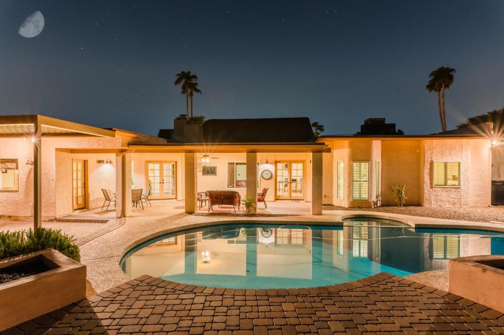 a swimming pool in front of a house at Desert Ridge by AvantStay Spacious Oasis w Pool Hot Tub in Phoenix