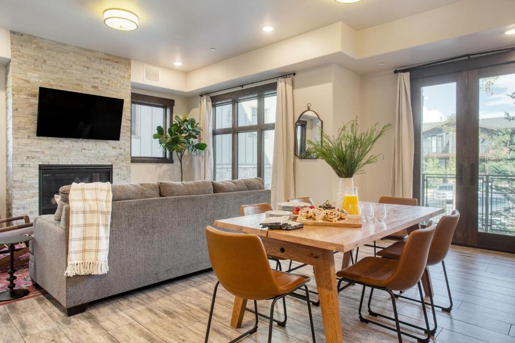 a living room with a table and a couch at Kestrel by AvantStay Close to the Ski Slopes in this Majestic Home in Park City in Park City