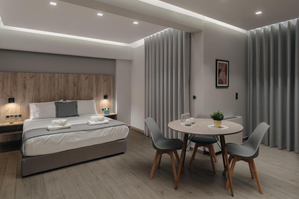 a bedroom with a bed and a table and chairs at Vialmar Premium Apartments in Rio