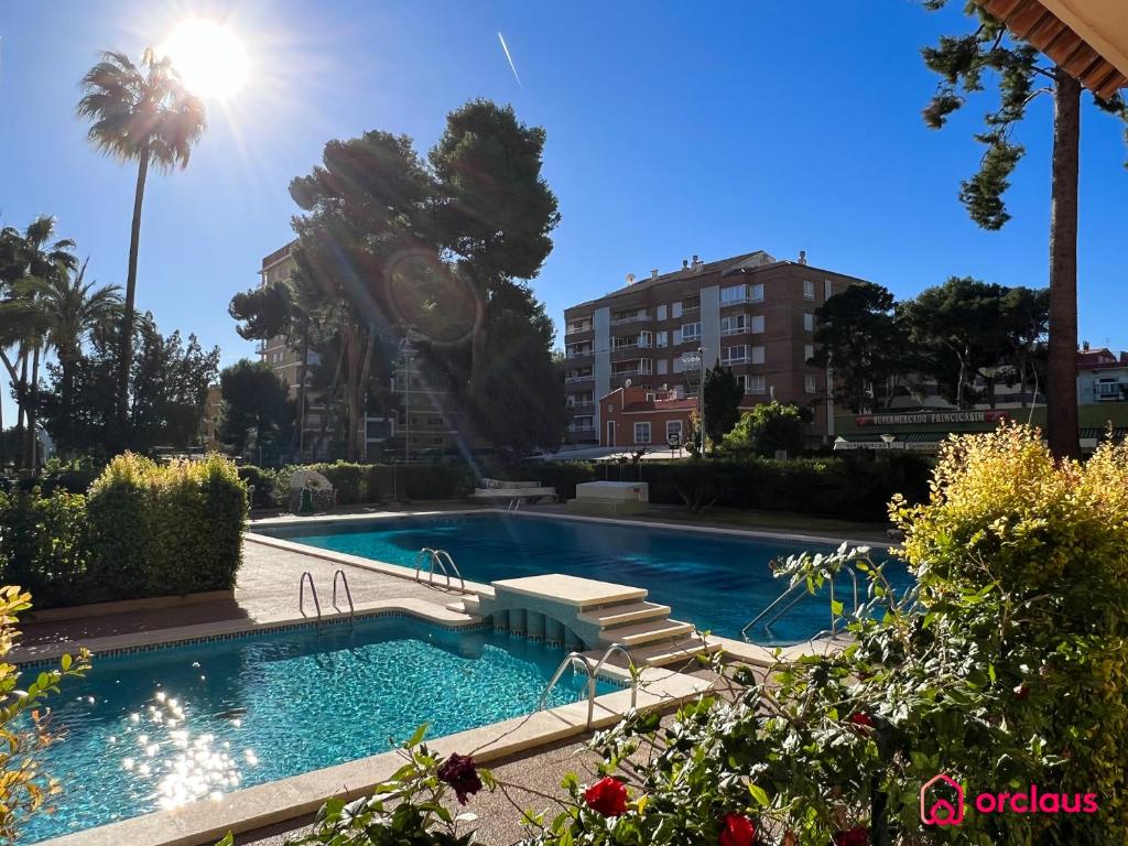 a swimming pool in front of a building at La Promenade in Benicàssim