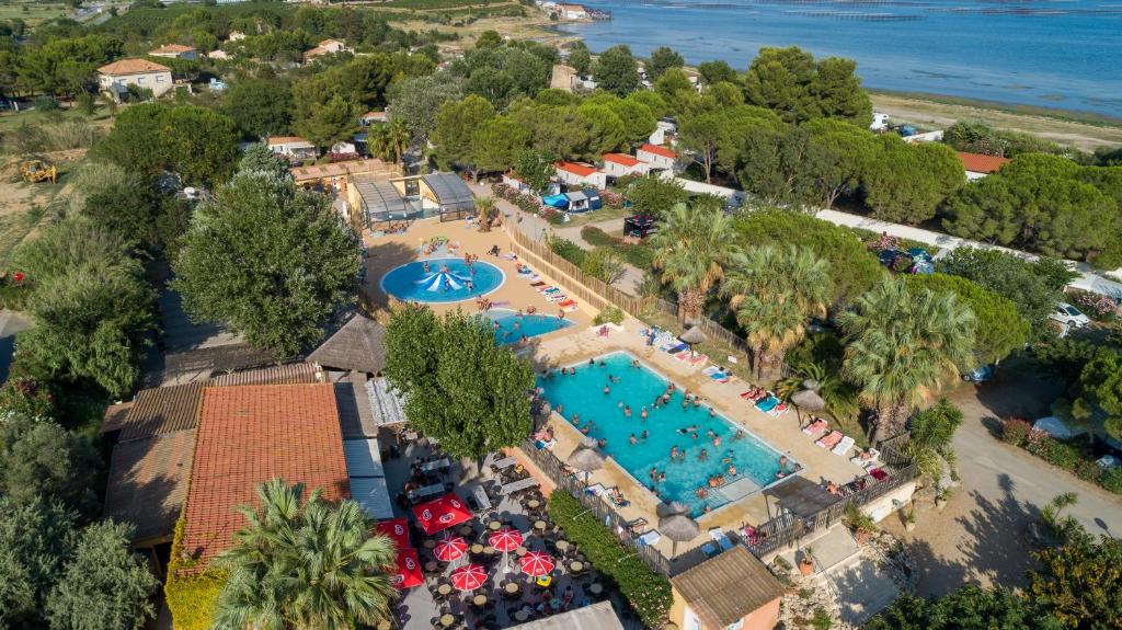 an overhead view of a resort with a pool at Camping Beau Rivage in Mèze