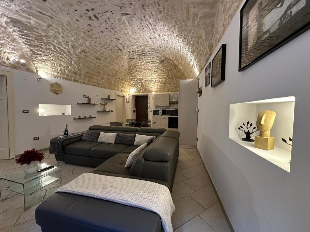 a living room with two couches and a living room with a ceiling at NG Collection Piazza Castello in Sassari