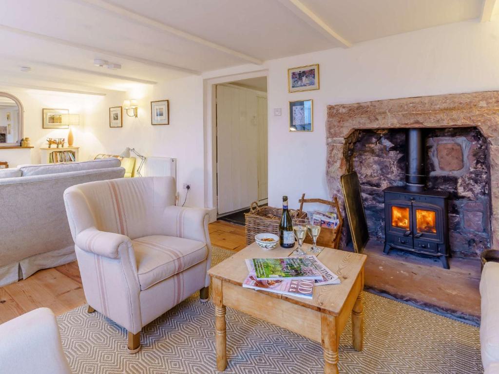 a living room with a couch and a fireplace at 4 Bed in Monmouth 42868 in Cwmcarvan