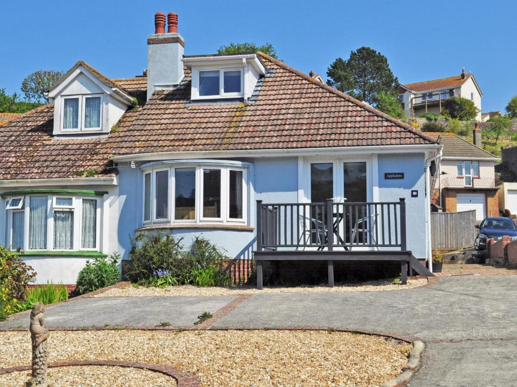 a white house with a porch and a balcony at 3 Bed in Brixham BX002 in Brixham