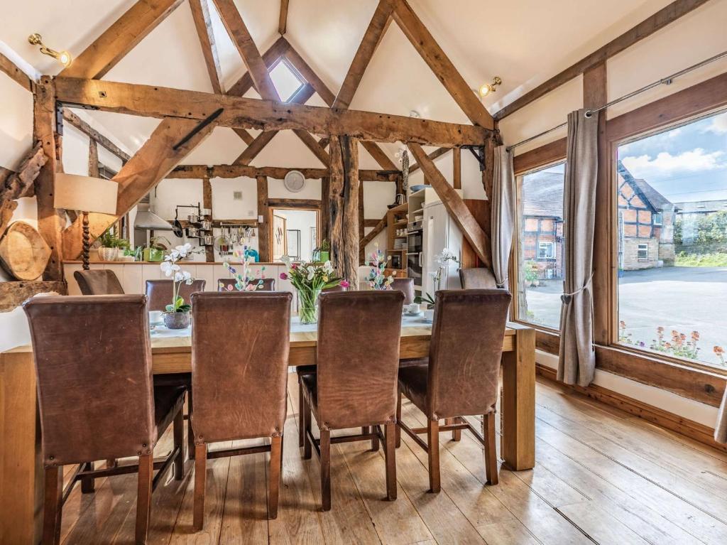 a dining room with a wooden table and chairs at 4 Bed in Nr Ludlow CHL22 in Aymestrey