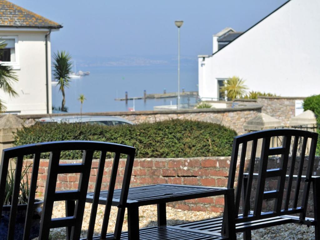 two chairs and a table on a patio at 1 Bed in Brixham BX031 in Brixham