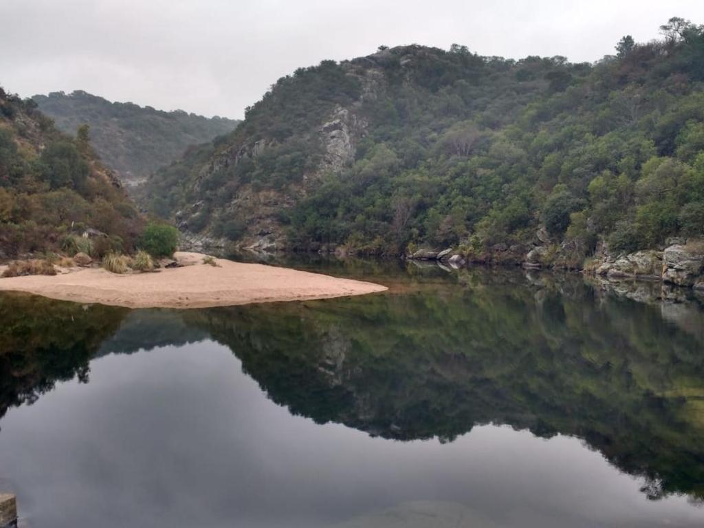 a large body of water with mountains in the background at Casa de adobe Cuesta blanca in Cordoba