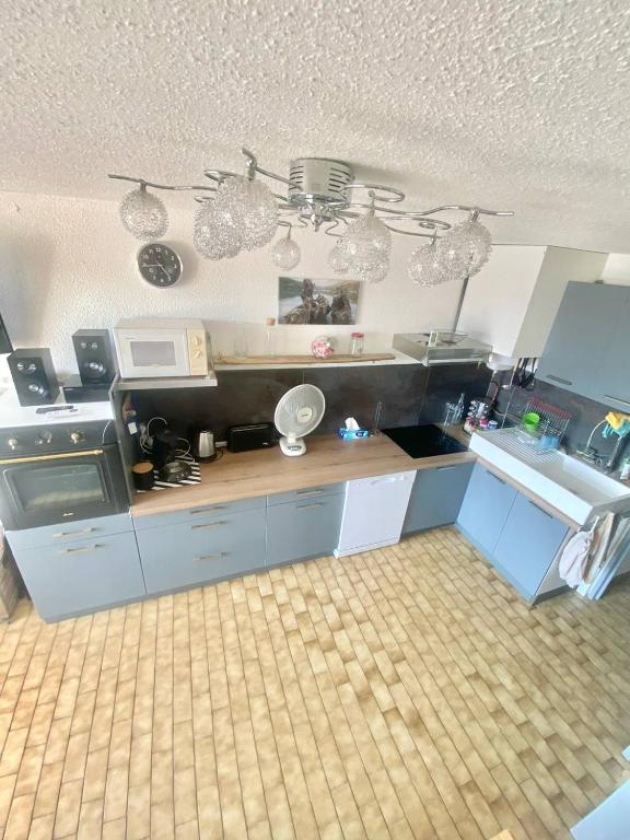 une cuisine avec un évier et un micro-ondes dans l'établissement studio cabine piscine proche des plages 4 personnes, au Grau-du-Roi